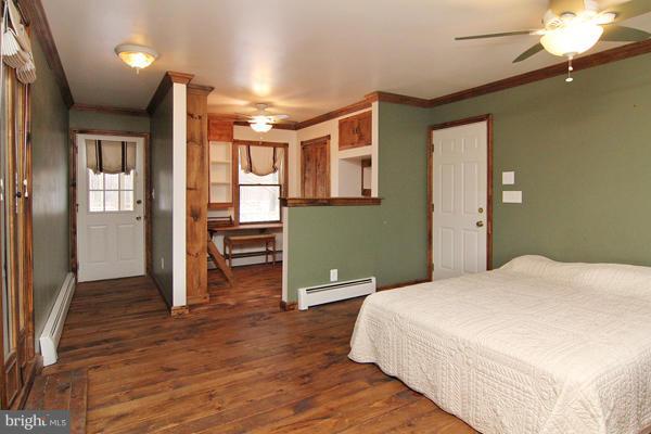 21601 Gunpowder Road Manchester, MD 21102 - Photo 6 of 30 a bedroom with a bed and a chandelier