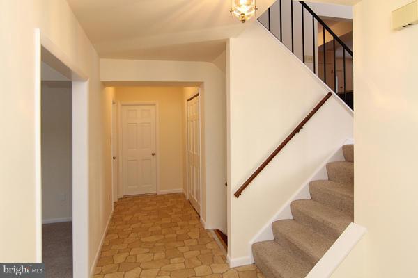 21601 Gunpowder Road Manchester, MD 21102 - Photo 9 of 30 a view of a hallway with wooden floor and staircase