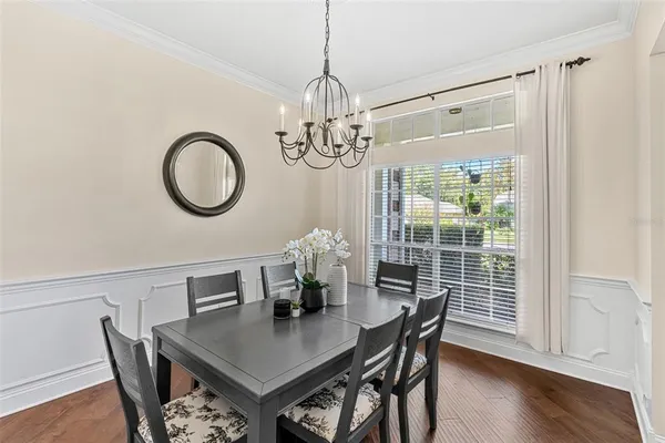 a view of a dining room with furniture window and wooden floor