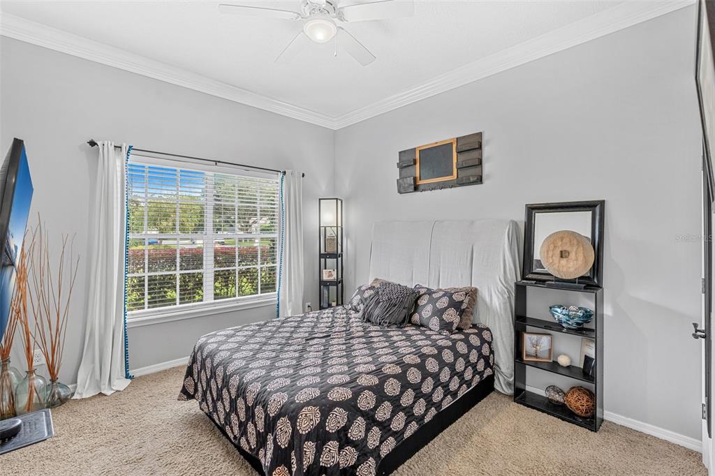 1674 Victoria Way Winter Garden, FL 34787 - Photo 23 of 42 a bedroom with a bed and a window