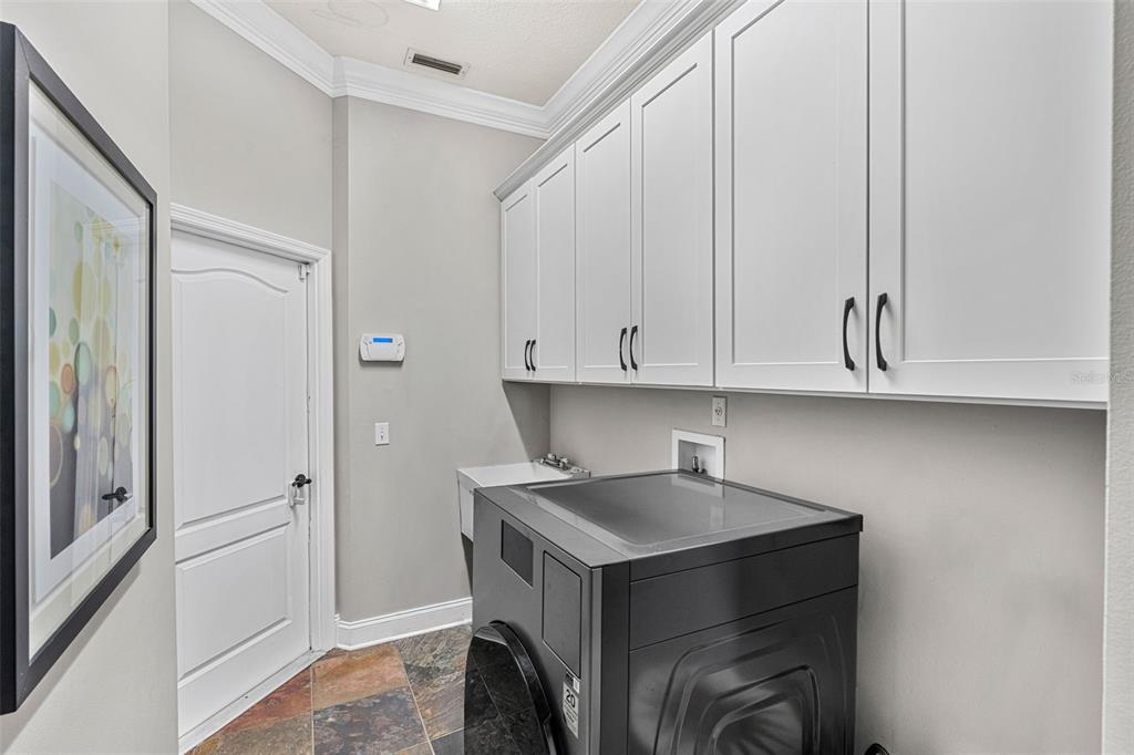 1674 Victoria Way Winter Garden, FL 34787 - Photo 26 of 42 a utility room with cabinets