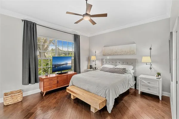 a bedroom with a bed and a large window