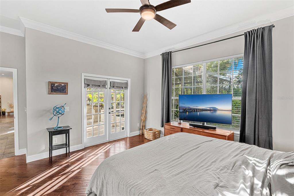 1674 Victoria Way Winter Garden, FL 34787 - Photo 28 of 42 a bedroom with a bed and a flat screen tv