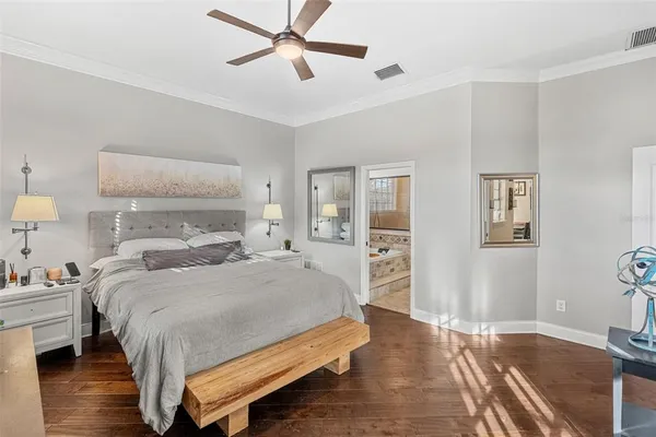 a bedroom with a bed and wooden floor