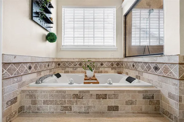 a bathroom with a bathtub and window