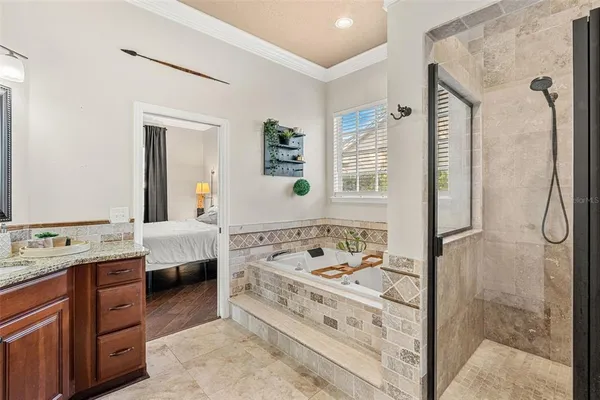 a bathroom with a tub a sink and a mirror