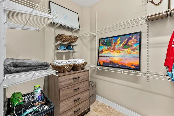 a kitchen with stainless steel appliances granite countertop a stove and a painting on the wall