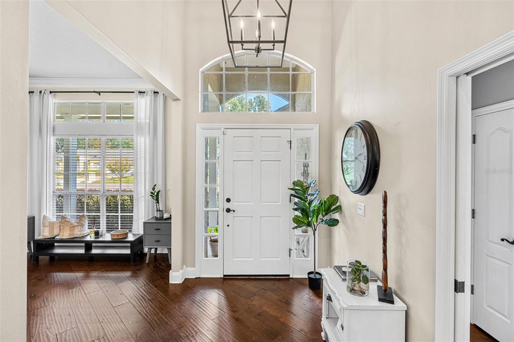 1674 Victoria Way Winter Garden, FL 34787 - Photo 7 of 42 a view of a hallway with wooden floor and a potted plant