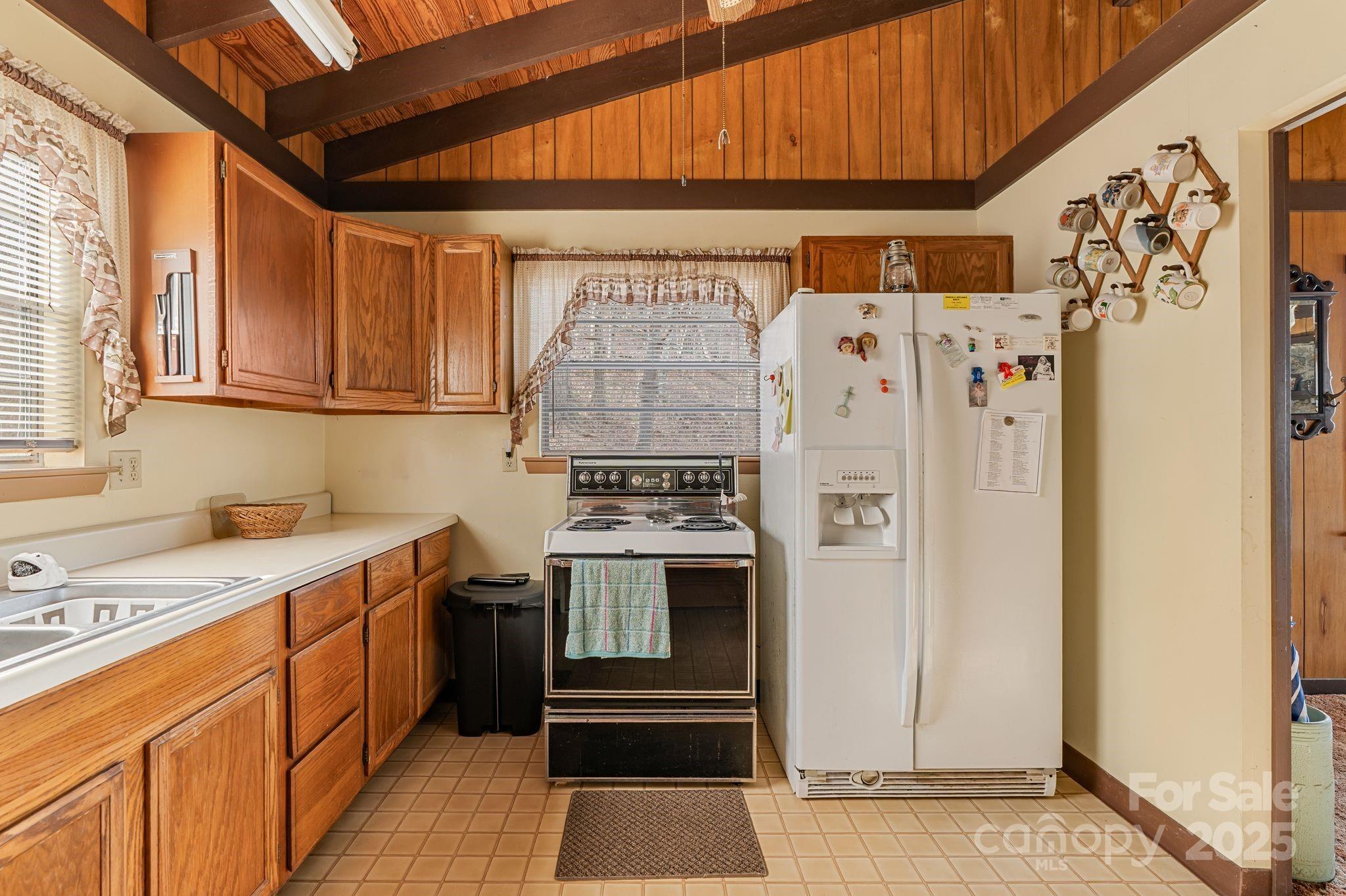 2650 Secluded Valley Road Marshall, NC 28753 - Photo 12 of 36 a kitchen with a stove a refrigerator and a sink