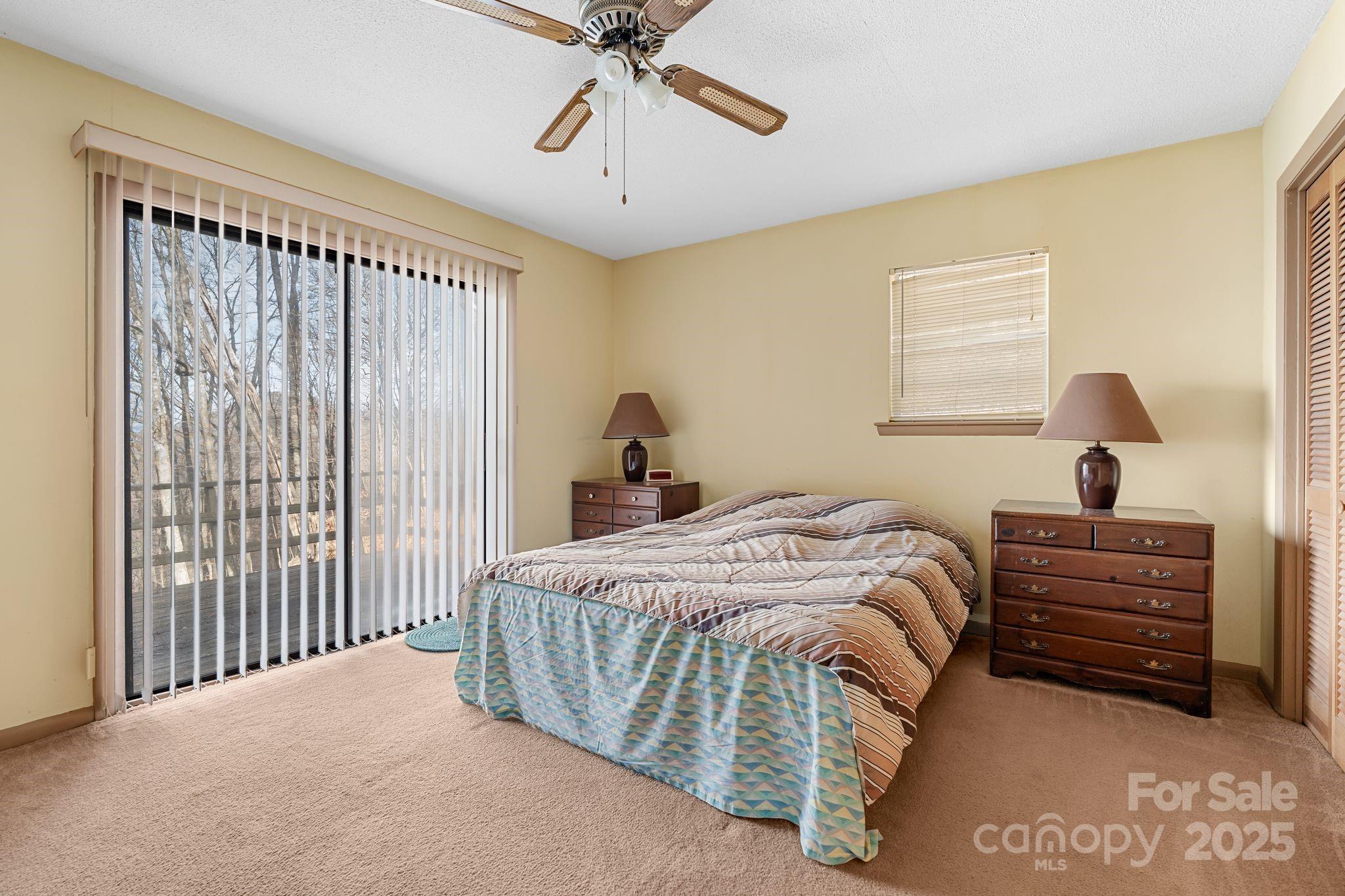 2650 Secluded Valley Road Marshall, NC 28753 - Photo 15 of 36 a bedroom with a bed and a chandelier