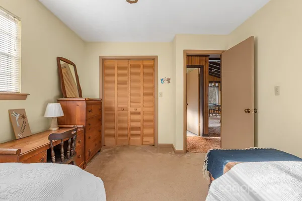 a bedroom with furniture and a window