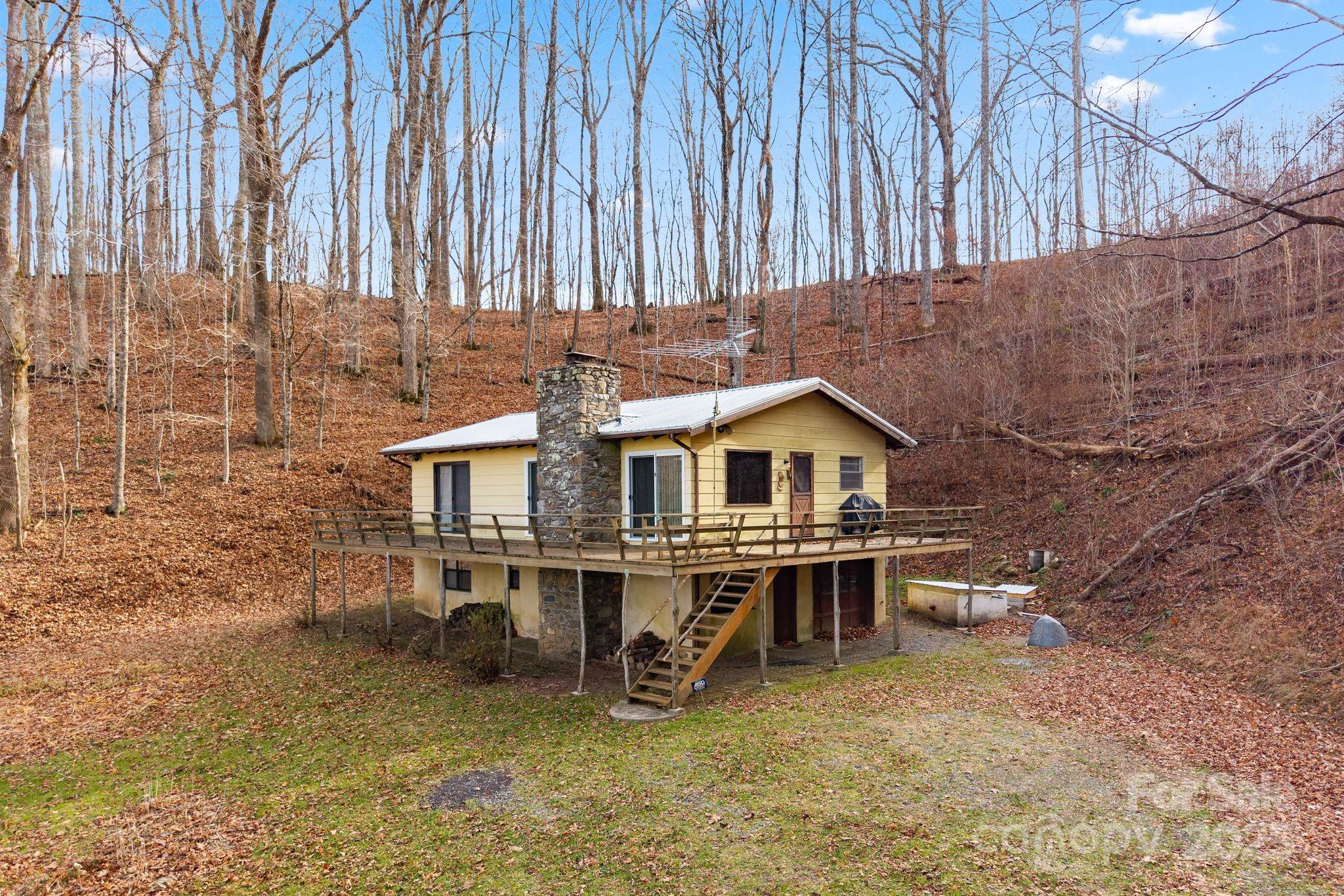 2650 Secluded Valley Road Marshall, NC 28753 - Photo 2 of 36 a view of a house with wooden deck and furniture