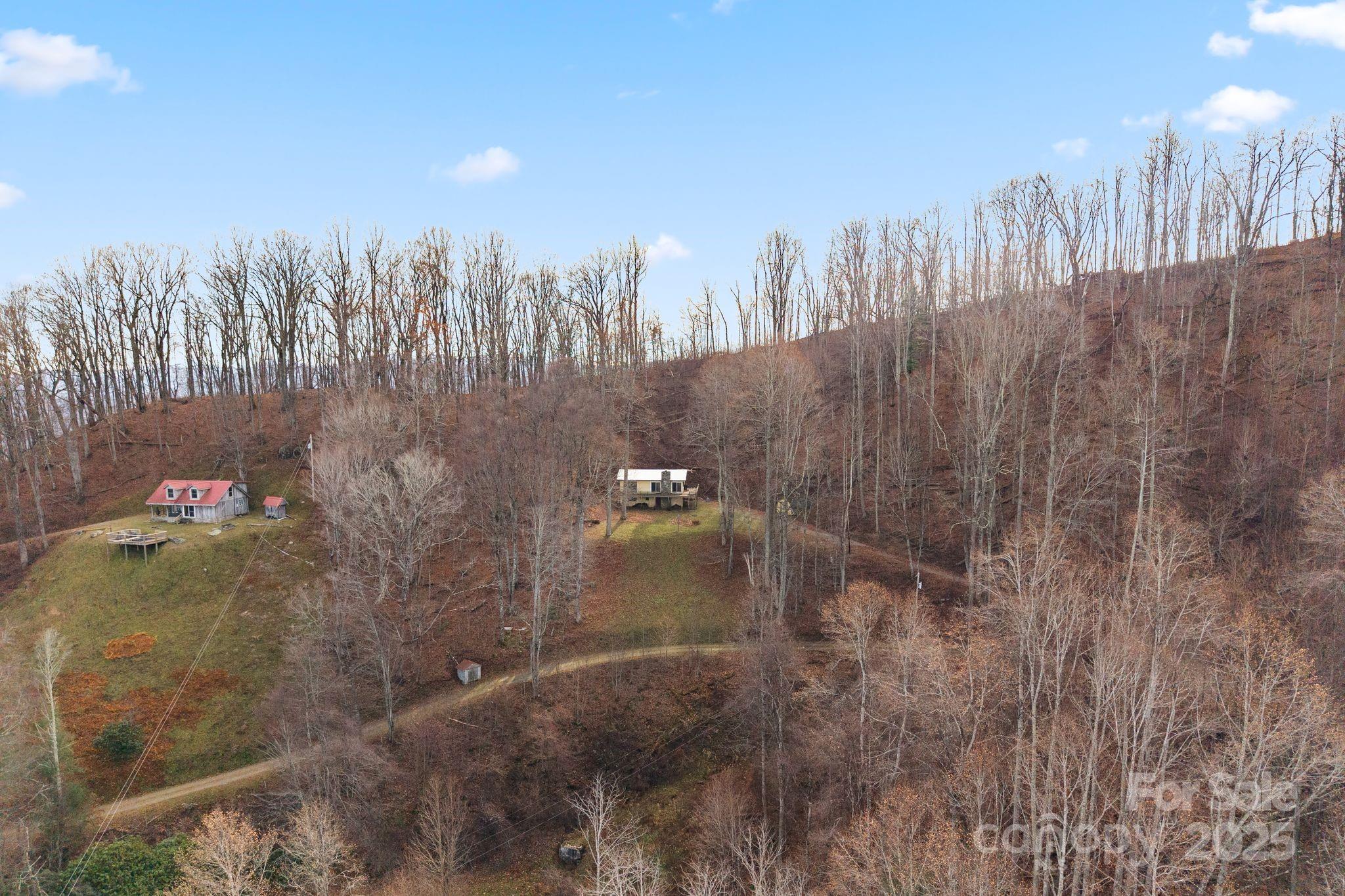 2650 Secluded Valley Road Marshall, NC 28753 - Photo 33 of 36 a view of a multi story residential apartment building with trees in the background