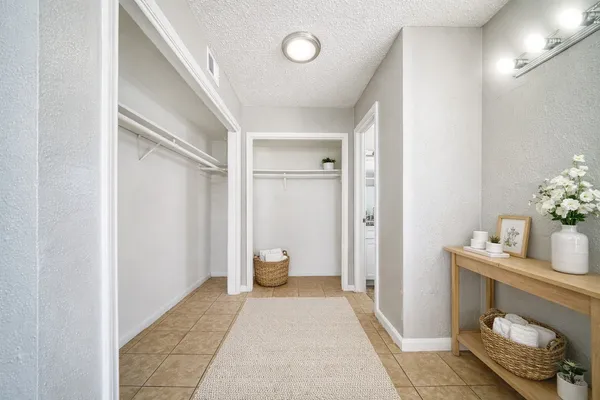 a bedroom with a bed and a potted plant