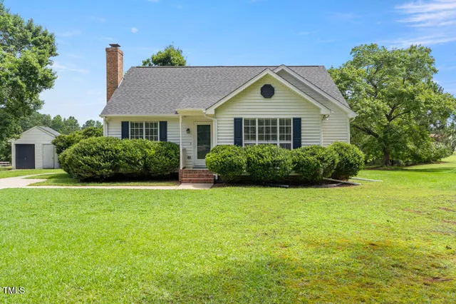 a front view of house with yard and green space