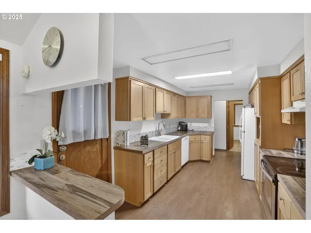 a kitchen with a refrigerator and a stove