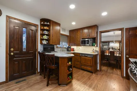 a kitchen with sink refrigerator and cabinets