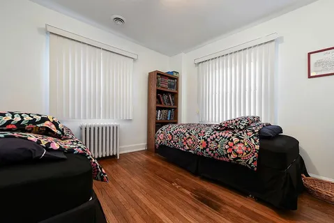 a bedroom with bed and a window