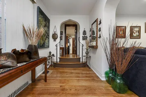 a view of entryway and hall with wooden floor