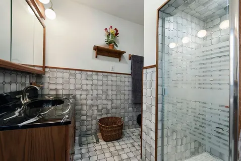 a bathroom with a sink a toilet and shower