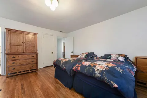 a bedroom with two bed and a closet