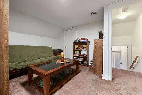 a living room with furniture a flat screen tv and a table