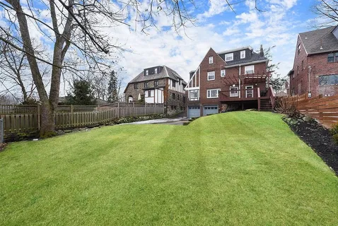 a view of a house with a yard and sitting area