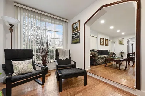 a living room with furniture and wooden floor