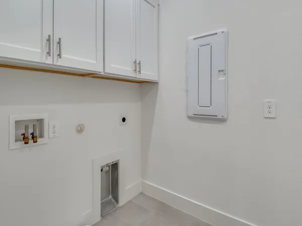 a view of cabinets and utility room with closet
