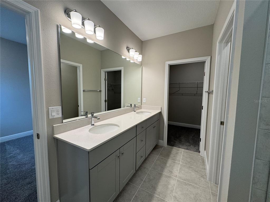 16434 Hamlin Hills Road Winter Garden, FL 34787 - Photo 26 of 50 a bathroom with a sink double vanity and a mirror