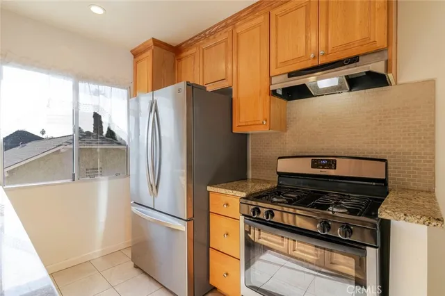 a kitchen with stainless steel appliances a refrigerator a stove and a sink