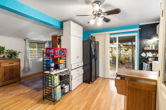 a kitchen with a refrigerator and a stove