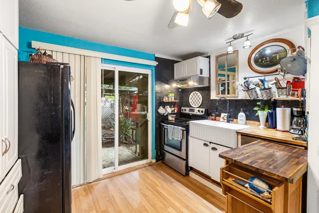 a view of a kitchen with stainless steel appliances granite countertop cabinets and a table