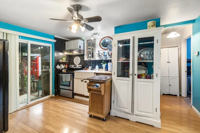 a stove top oven sitting inside of a kitchen