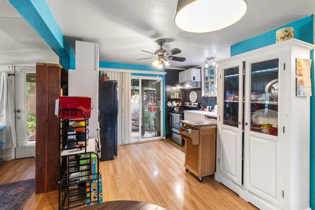 a living room with furniture ceiling fan and a window