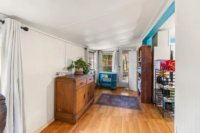 a living room filled with furniture and a potted plant