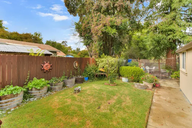 a backyard of a house with table and chairs