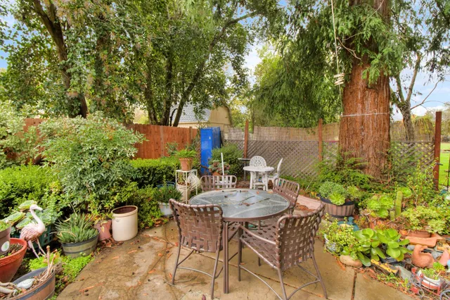 a patio with sofas fire pit table and chairs