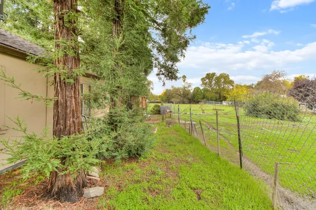 a view of patio with couches and table and chairs under an umbrella