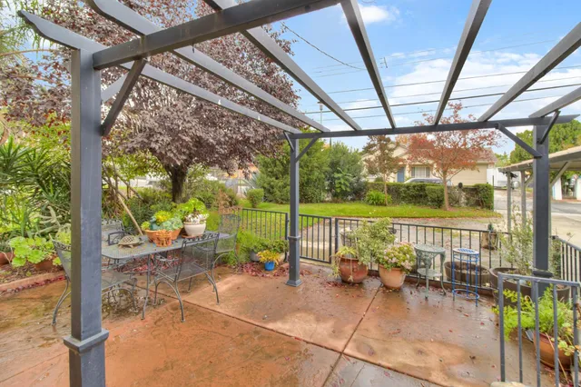 a view of a house with a yard and potted plants