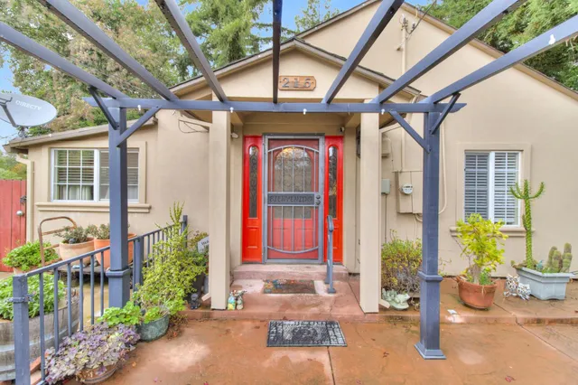 a front view of a house with outdoor seating and a garden