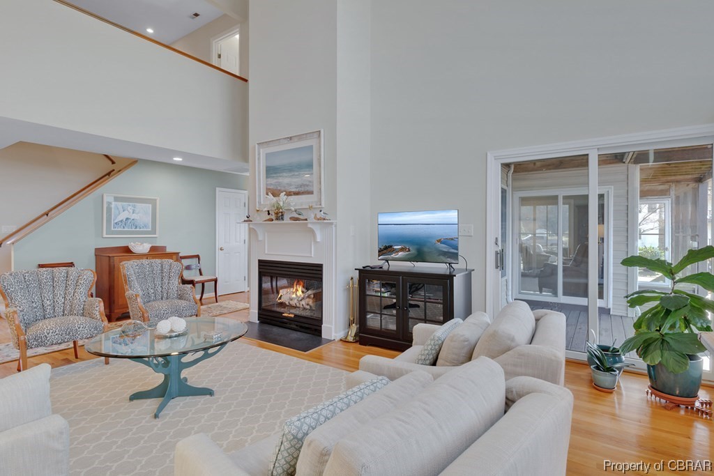 362 Beach Creek Road Lancaster, VA 22503 - Photo 10 of 47 Living room with a towering ceiling and light hardwood / wood-style floors