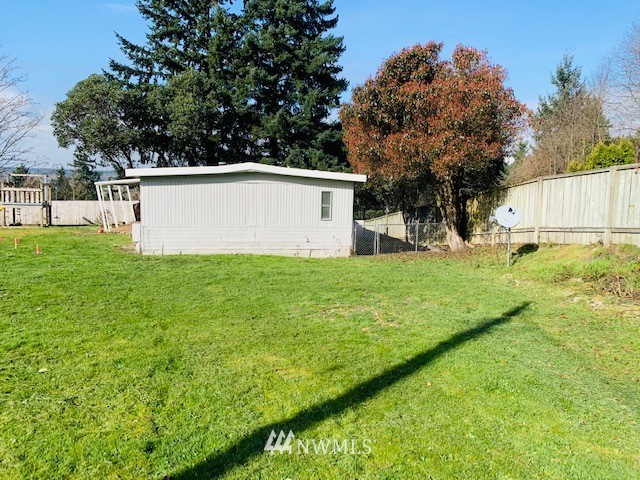 11023 Karshner Road East Edgewood, WA 98372 - Photo 3 of 16 a view of a backyard with large trees