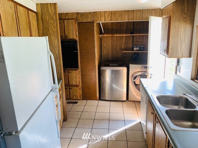 11023 Karshner Road East Edgewood, WA 98372 - Photo 5 of 16 a kitchen with stainless steel appliances a refrigerator and a sink