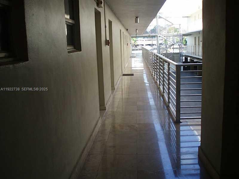 1441 Lincoln Road, Unit 308 Miami Beach, FL 33139 - Photo 2 of 10 a view of a hallway with wooden floor