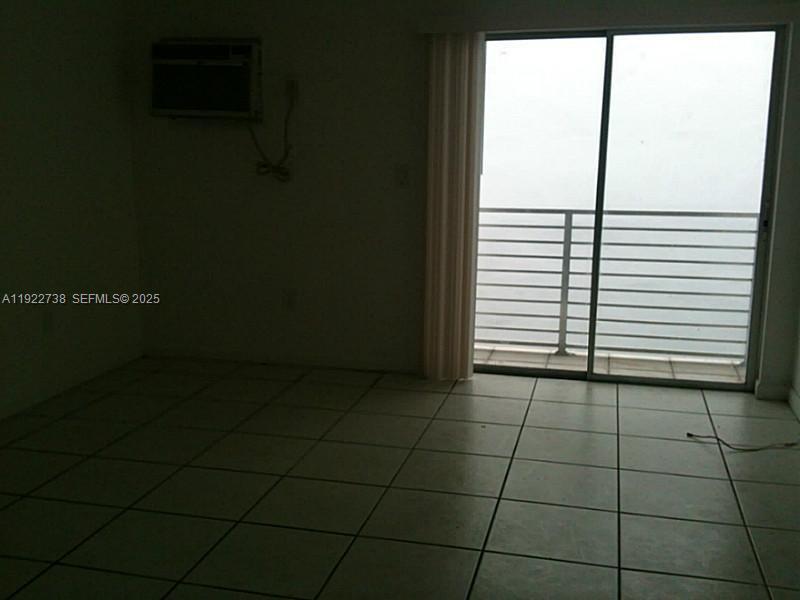 1441 Lincoln Road, Unit 308 Miami Beach, FL 33139 - Photo 6 of 10 a view of a livingroom with an empty space and a window
