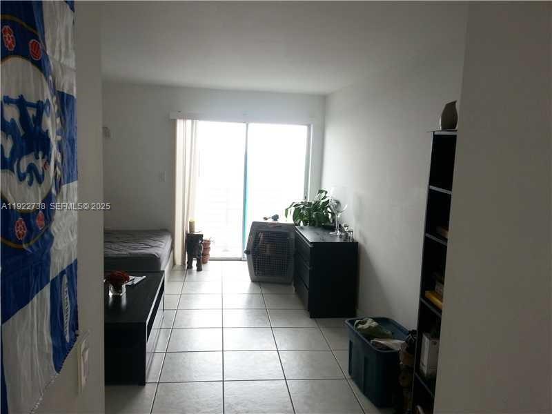 1441 Lincoln Road, Unit 308 Miami Beach, FL 33139 - Photo 7 of 10 a living room with furniture and a fireplace