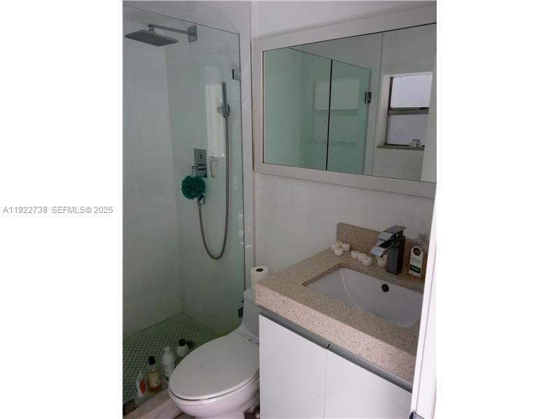 1441 Lincoln Road, Unit 308 Miami Beach, FL 33139 - Photo 9 of 10 a bathroom with a sink toilet and shower