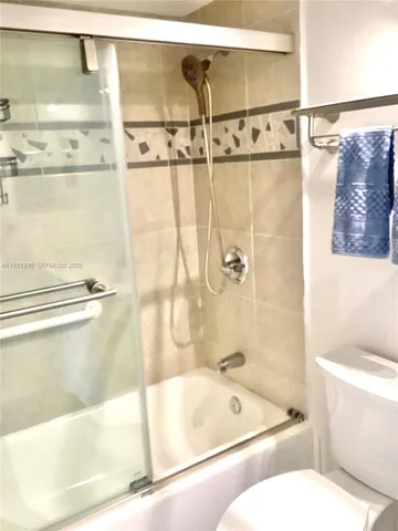 a bathroom with a bathtub and shower