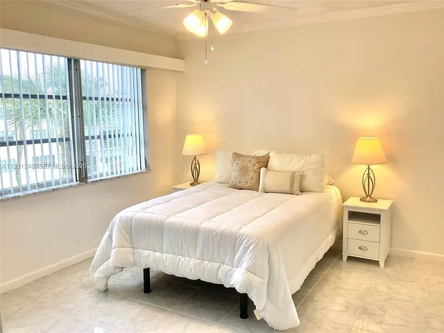 a bedroom with a bed and a night stand